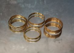 A 9ct rose gold band, size O, 2.16g; a 9ct three gold Russian wedding ring, size O, 1.89g; a