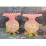A pair of Victorian satin glass globular vases, with flared frilly rims, applied with vaseline