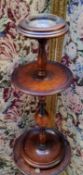 An early 20th century two tier smoker's stand, inset glass ashtray above circular dished top