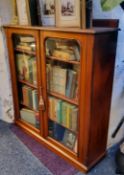 A Victorian mahogany bookcase, arced glazed doors, plinth base, 114cm high, 105cm wide, c.1870