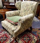 An early 20th century wingback club chair, tapestry type upholstery c.1930