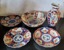 A pair of Japanese shaped circular Imari plates, decorated in the typical palette, 22cm diam,