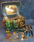 A vintage Goldenman travel vanity case containing a quantity of costume jewellery including