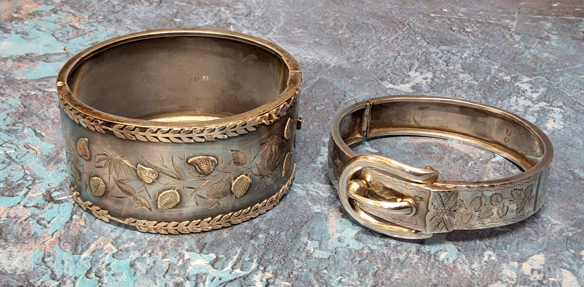 A Victorian silver hinged buckle bangle, chased and engraved with foliate, Lawrence Emanuel,