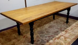 A substantial 'Victorian' golden oak farmhouse dining table, turned ebonised legs with small