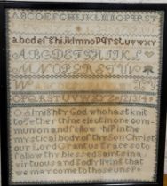 A late 19th century neeldework sampler, embroidered with alphabet and verse, 32cm x 27cm, framed