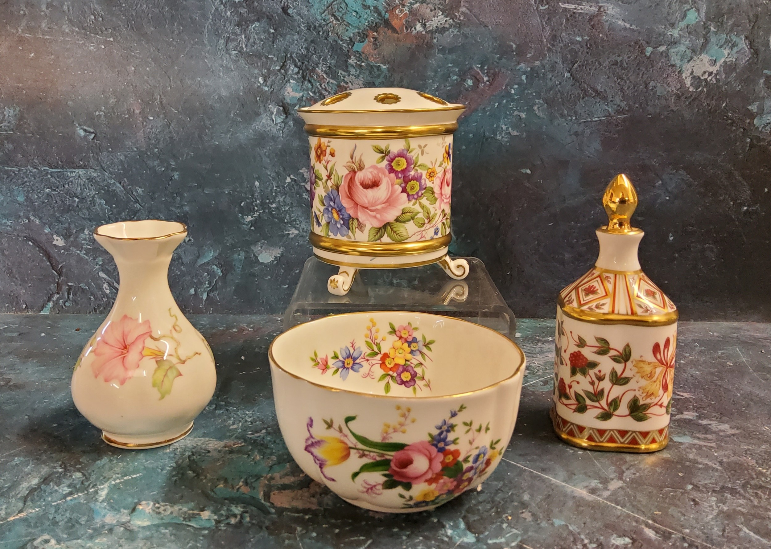 A Lynton porcelain cylindrical bough pot and cover, painted with colourful summer flowers,  gilt