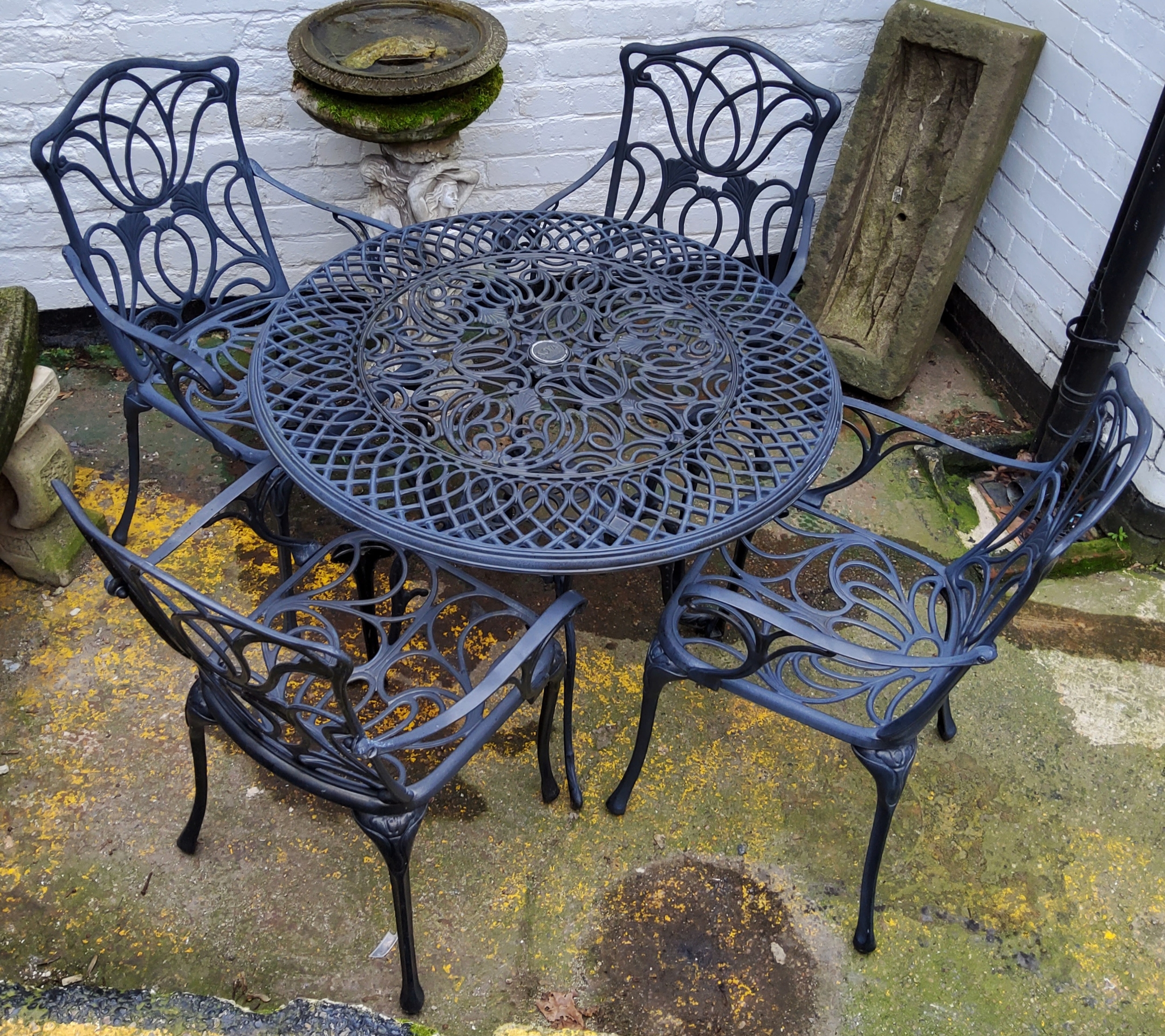 A Nova outdoor furniture set, including cast metal table and four Art Nouveau inspired armchairs