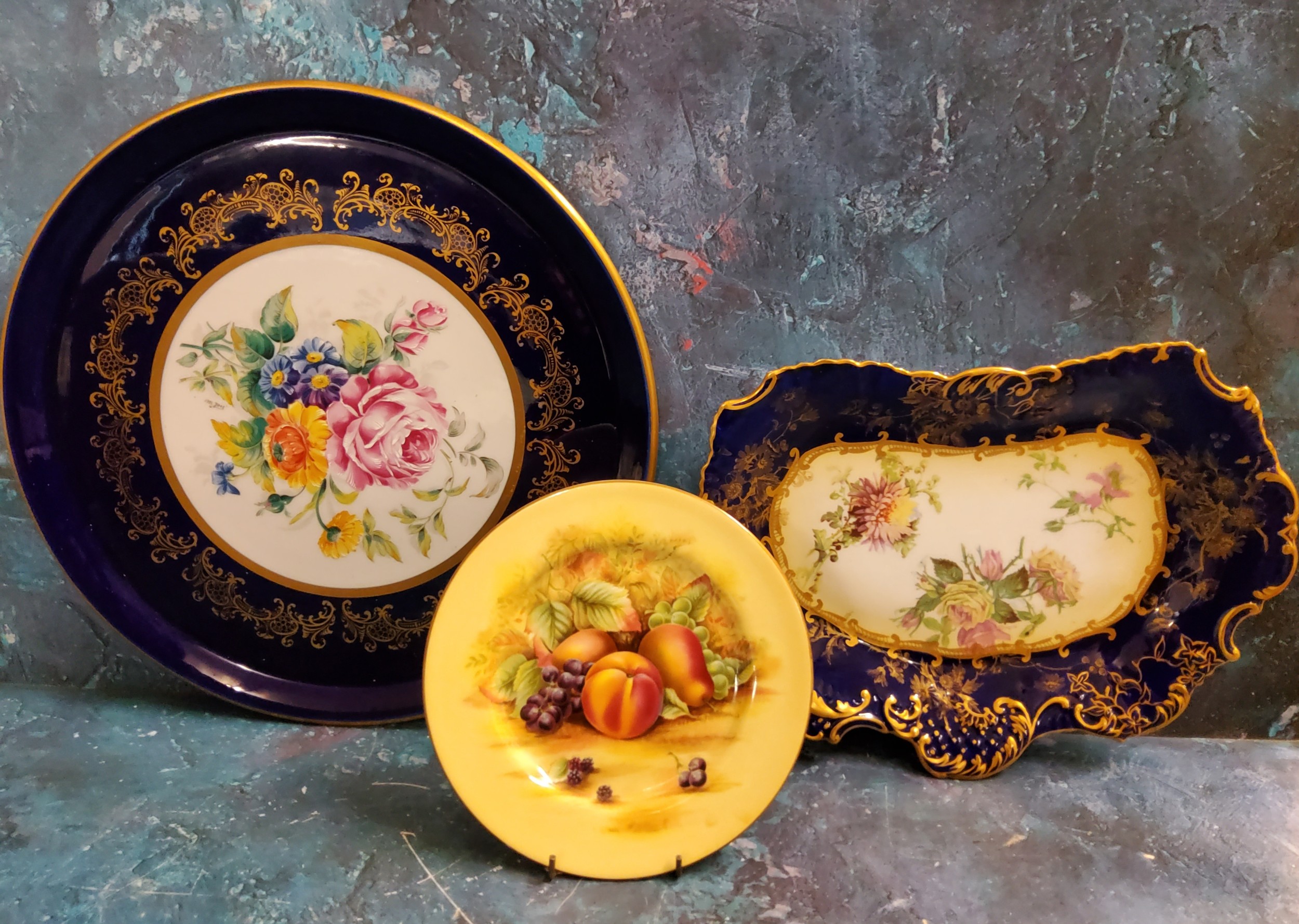 An Aynsley Orchard Gold side plate;  a Limoge circular tray the field painted with colourful