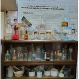 A large collection of Victorian and later pharmaceutical apothecary bottles, cream jars and pestle