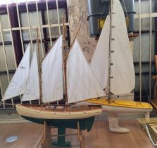 A wooden pond yacht, with masts, sails and rigging, with painted hull and deck, 70cm wide, c.