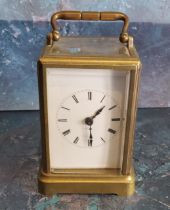 An early 20th century brass carriage clock, Roman numerals, swing handle, 11cm high, c.1910