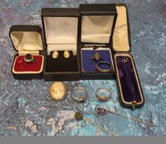 A yellow metal mounted cameo; a pair of cameo earrings; a silver ring set with a central oval purple