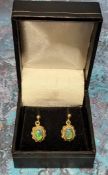 A pair of 9ct gold earrings set with oval black opals, 2.65g gross