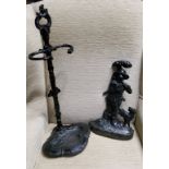 A Victorian style cast iron stick stand, 64cm high;  an iron door stop, cast with forester and his