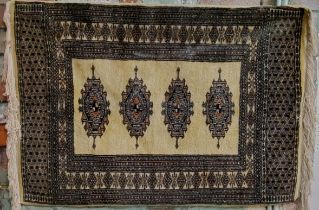 A Pakistani Bokhara rug in vivid tones of gold, black and light brown