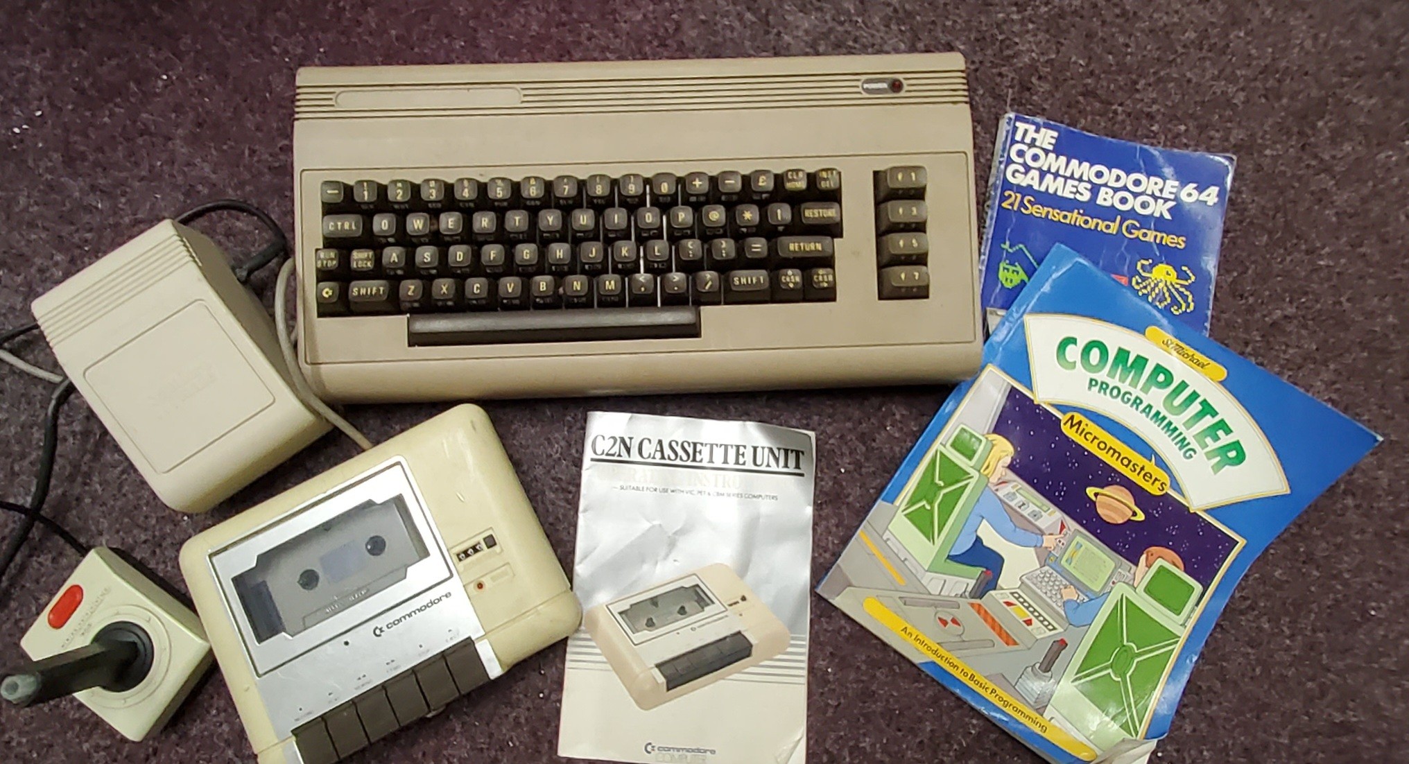 A Commodore 64 computer, instruction book;  etc