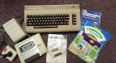 A Commodore 64 computer, instruction book;  etc