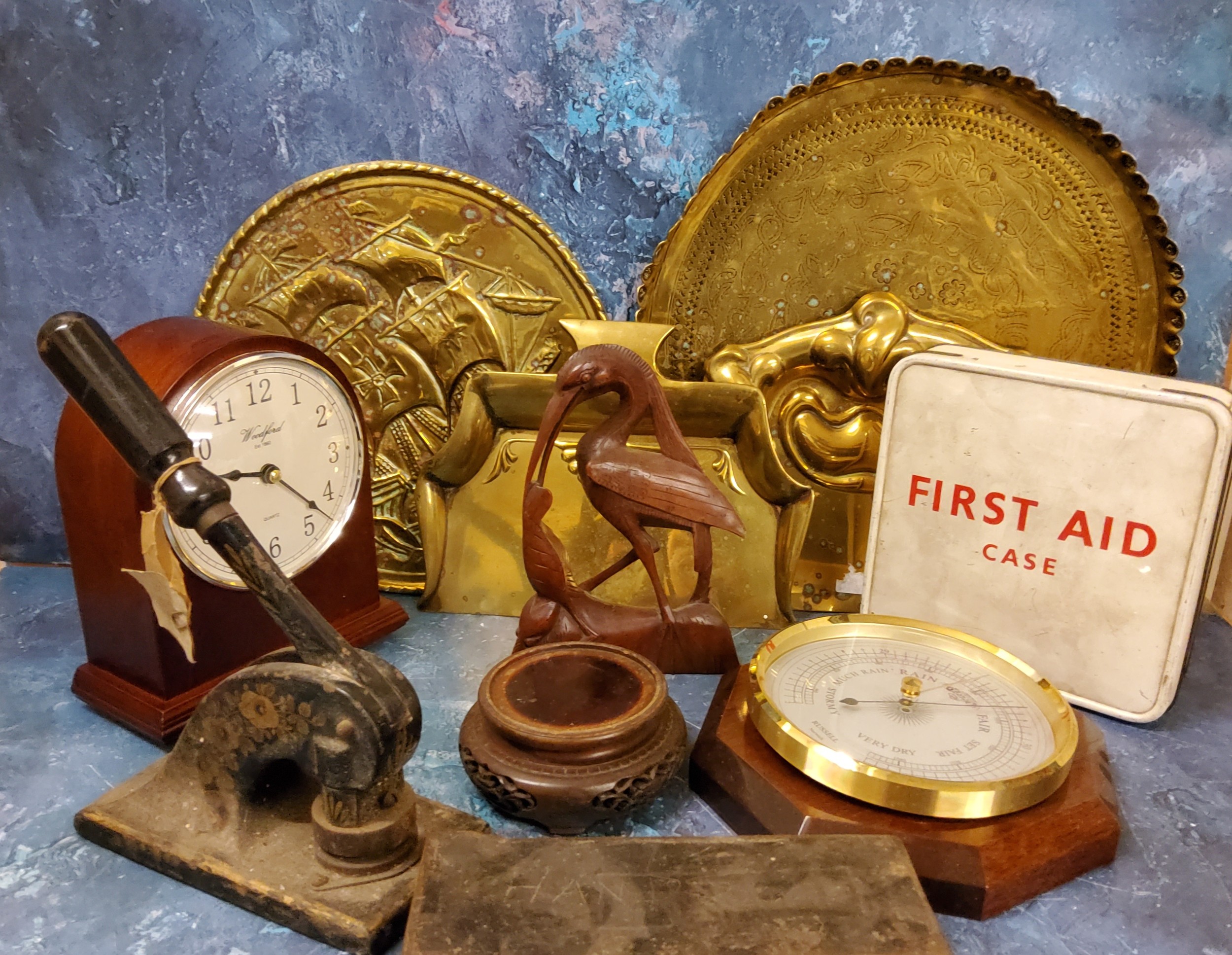 An Art Nouveau brass crumb tray;  another;   a Woodford mahogany mantel clock;  a Russel barometer;