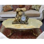 A mid century gilt metal and onyx coffee table