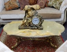 A mid century gilt metal and onyx coffee table