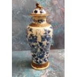 A Chinese crackle glazed vase and cover, decorated in cobalt blue with scrolling dragons, 27cm high,