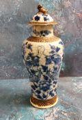 A Chinese crackle glazed vase and cover, decorated in cobalt blue with scrolling dragons, 27cm high,