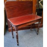 A 19th century mahogany folding tea table, rounded rectangular top, secret compartment, turned legs,