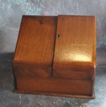 A Victorian oak slope front stationery box, waterfall interior, 27cm high, 30cm wide, c.1880