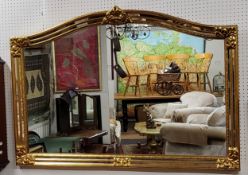 A large decorative gilt over mantel mirror, acanthus capped to frame with double 'antique' foxed