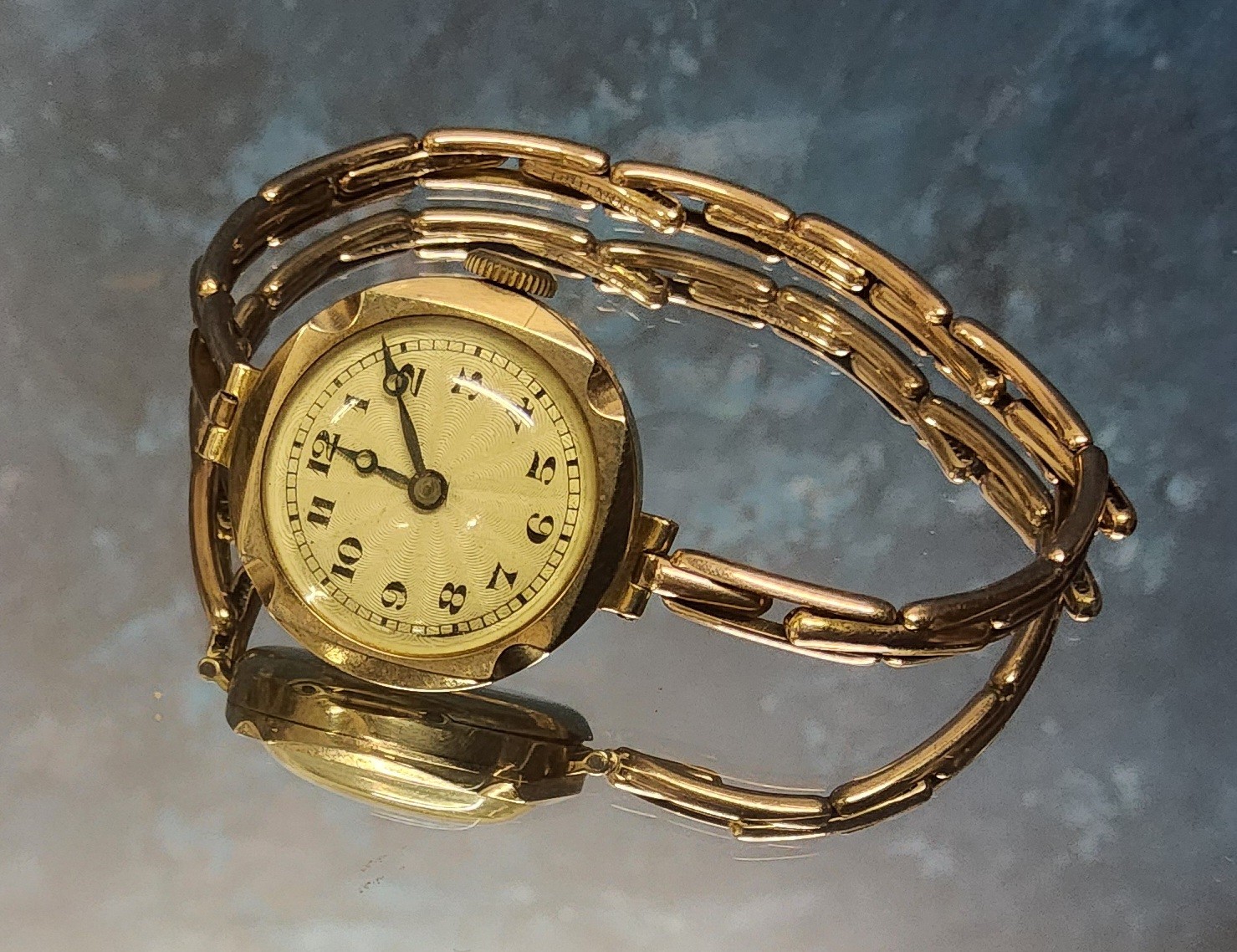 A 9ct gold lady's watch, Swiss 15 jewel movement cream engine turned dial, Arabic numerals, 9ct gold
