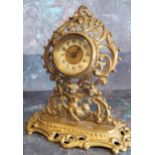 A Victorian brass mantel clock, the dial with Arabic numerals, pierced leafy scroll and cherub case,