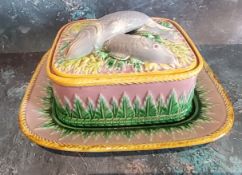 A George Jones majolica sardine dish, the cover with three crossed sardines on a bed of fronds,