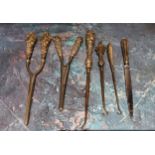 A pair of Victorian silver hafted glove stretchers;  another;    three silver hafted button