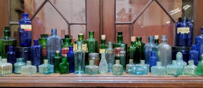 Advertisement & apothecary jars including two 19th century green glass bottles with gilded lozenges,