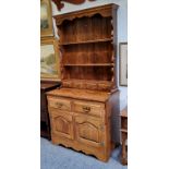 A bespoke 20th century oak dresser, shaped apron above two shelves and four spice drawers, the