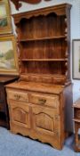 A bespoke 20th century oak dresser, shaped apron above two shelves and four spice drawers, the