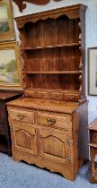 A bespoke 20th century oak dresser, shaped apron above two shelves and four spice drawers, the