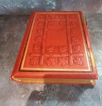 A Victorian red morocco leather and brass mounted photograph album, embossed with leaves, 30cm high,