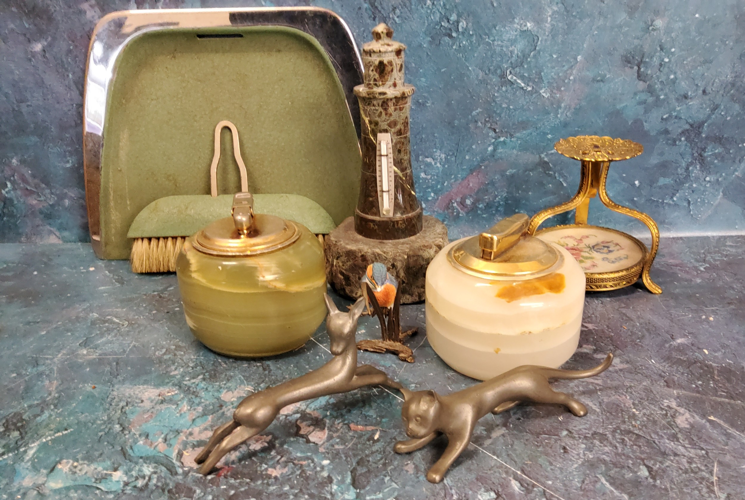 A serpentine light house thermometer;  two onyx table lighters;  a Etainfin pewter stylised cat;