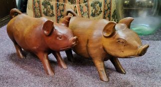 A near pair of Indonesian hardwood pigs