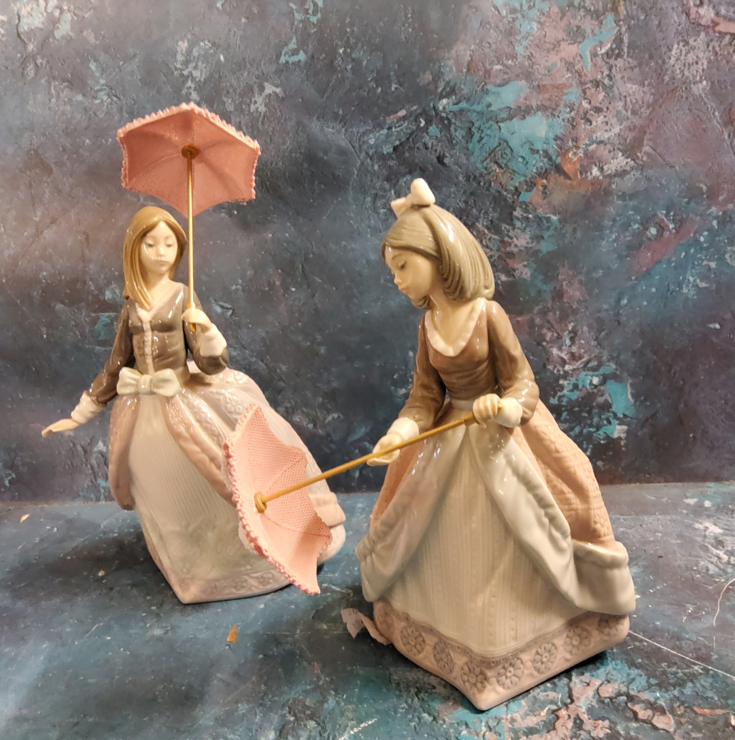 A Lladro figure, Jolie, with parasol,  printed mark, no. 5210;  another, Angela, with parasol,