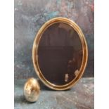 A silver oval easel photograph frame, 20.5cm high, Sheffield 1996;  a silver coloured metal egg,