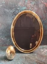 A silver oval easel photograph frame, 20.5cm high, Sheffield 1996;  a silver coloured metal egg,