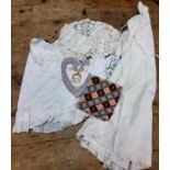 Textiles - a Victorian cotton night gown;  silk and lace child's clothes;  a heart shaped needle