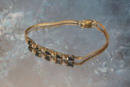 A 14ct gold bracelet, the five central links claw set with blue oval stones, with four diamond chips