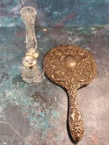 A silver hand mirror, embossed with leafy scrolls and masks;   a silver mounted and glass bud
