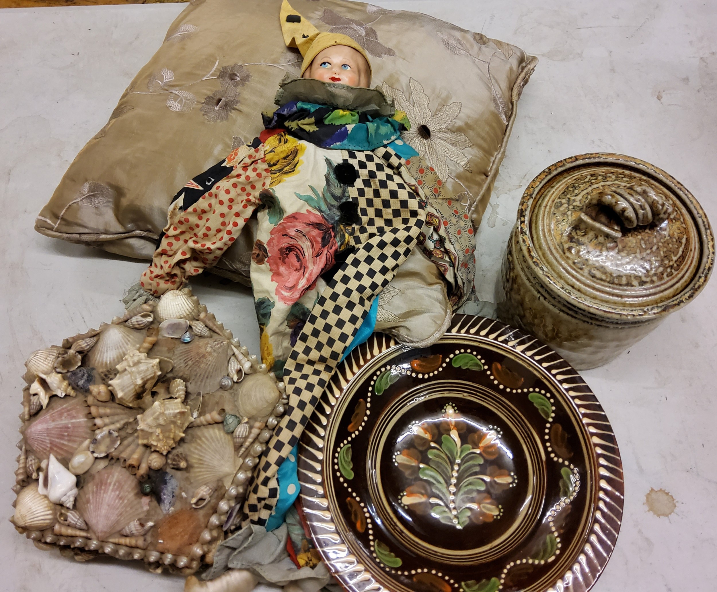 A silk embroidered cushion;   a shell encrusted box;  stoneware storage jar;   a Commedia dell'