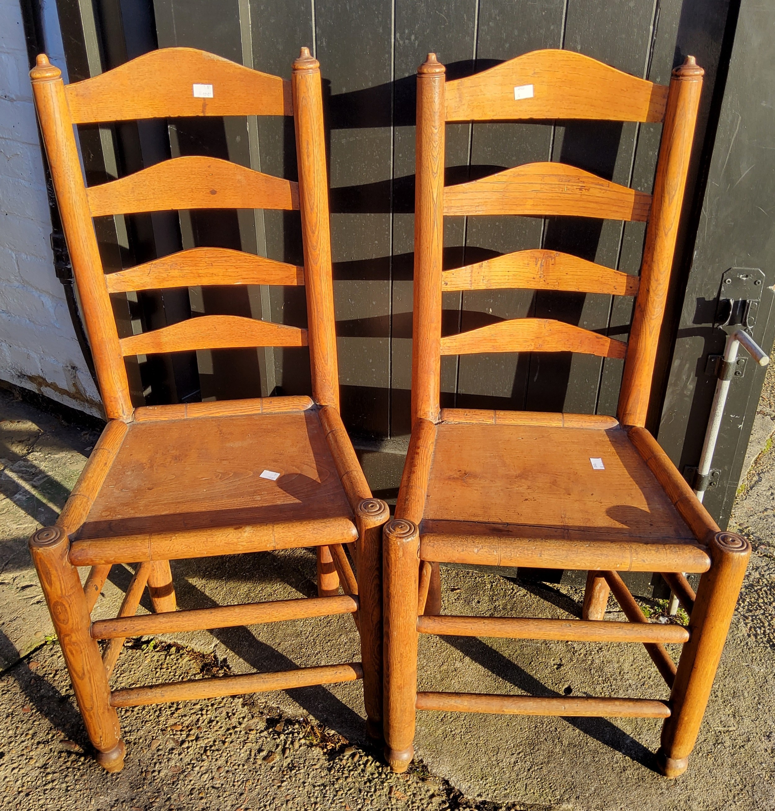 A pair of 19th century simulated bamboo elm ladder back chairs, c.1890