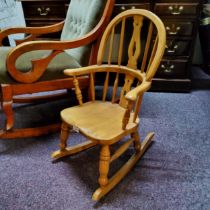 An early/ mid 20th century beech bow backed rocking chair, pierced splat, H-steetcher on turned legs